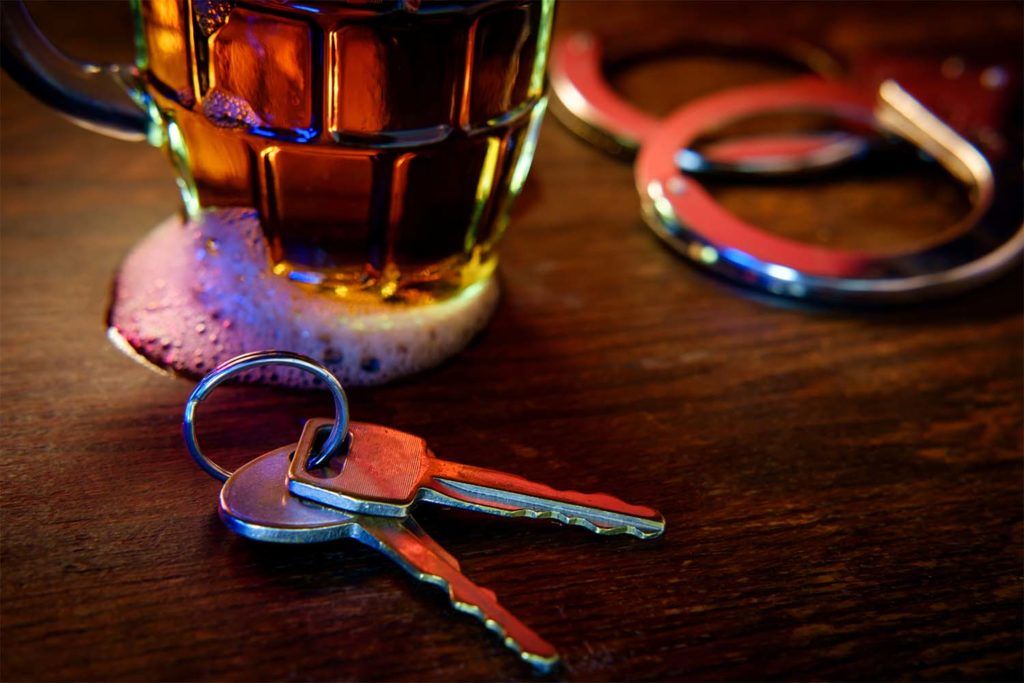 DUI concept - alcohol, keys, handcuffs